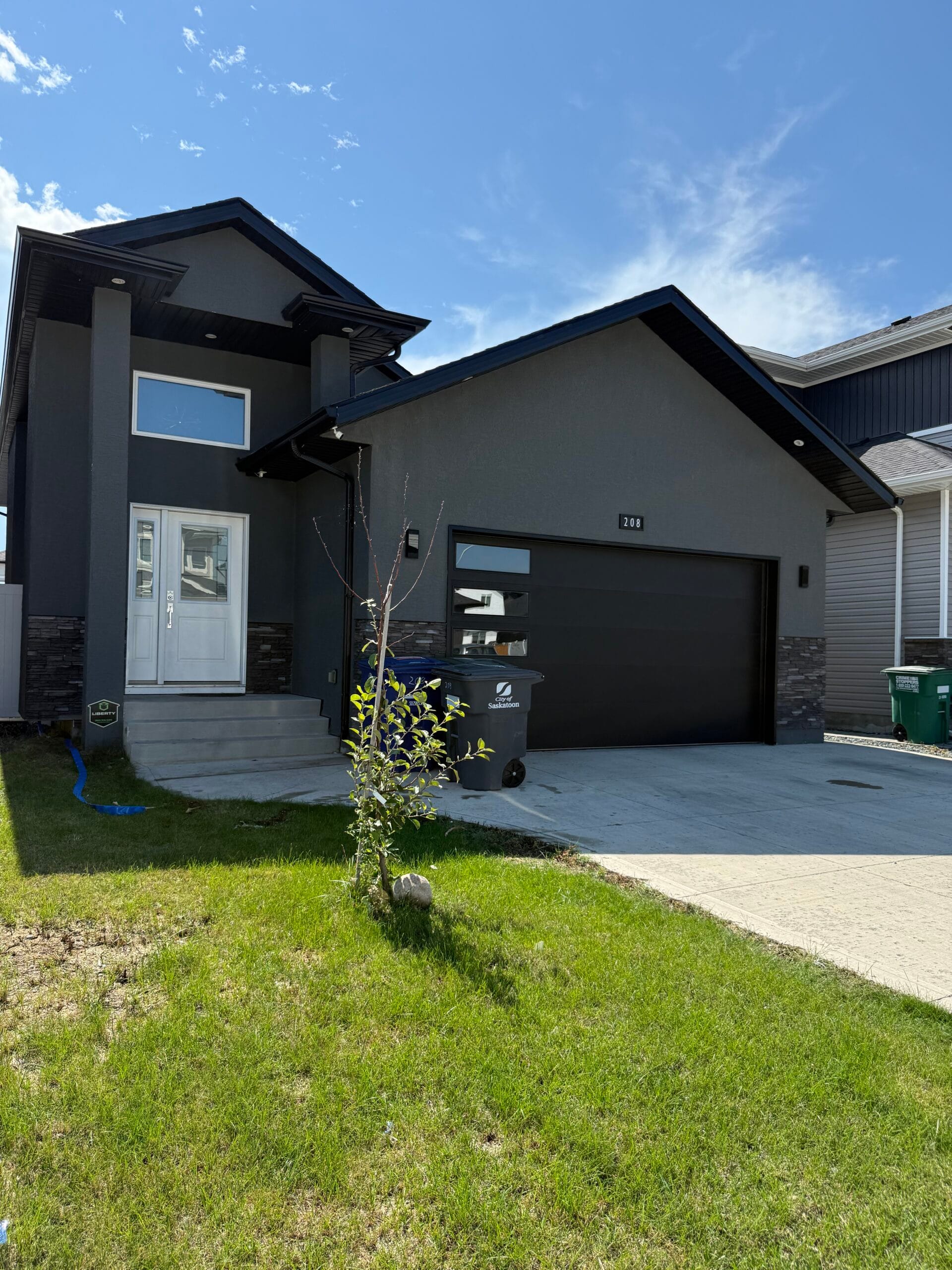 Modern 4-bedroom home in Aspen Ridge with landscaped yard, deck, patio, and bright open-concept living space